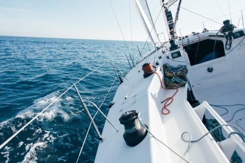 deck-professional-sailboat-racing-yacht-during-competition-sunny-windy-summer-day-moving-fast-through-waves-water-with-spinnaker-up (1)